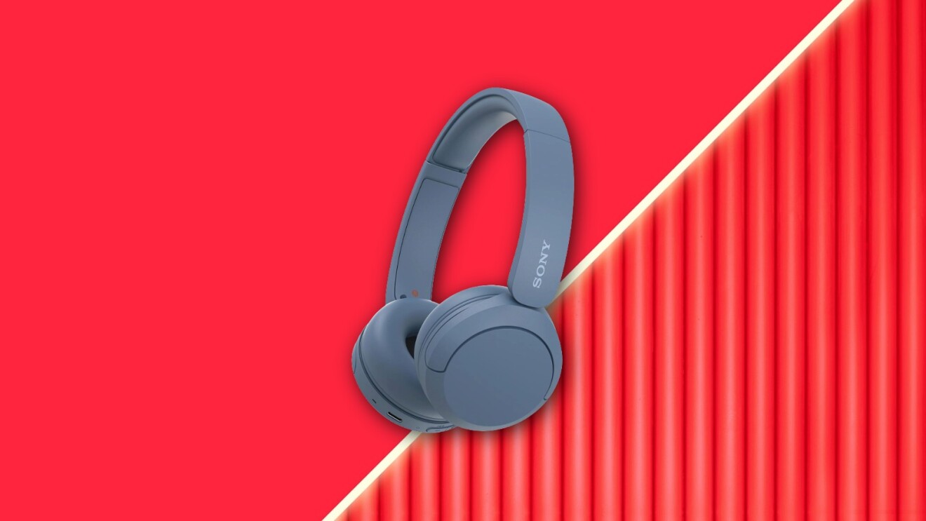 Blue Sony wireless headphones on vibrant red background