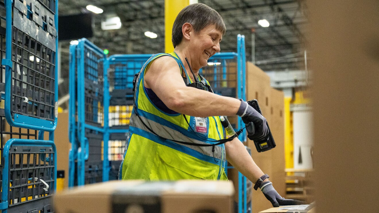 Amazon employee works in a fulfillment center.