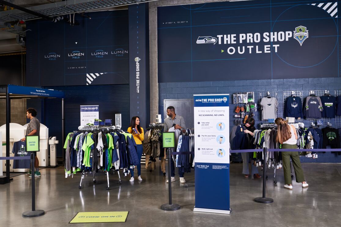 A photo of customers shopping at a store in Lumen Field that uses Just Walk Out technology.