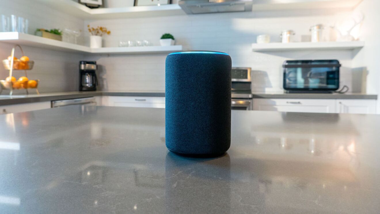 An Echo device on a kitchen island in a home.