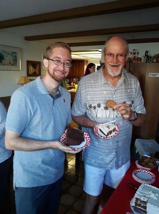 Two men stand together in a living room. Tim (left) received a kidney from his uncle Jerry (right) and pose together for an image. 