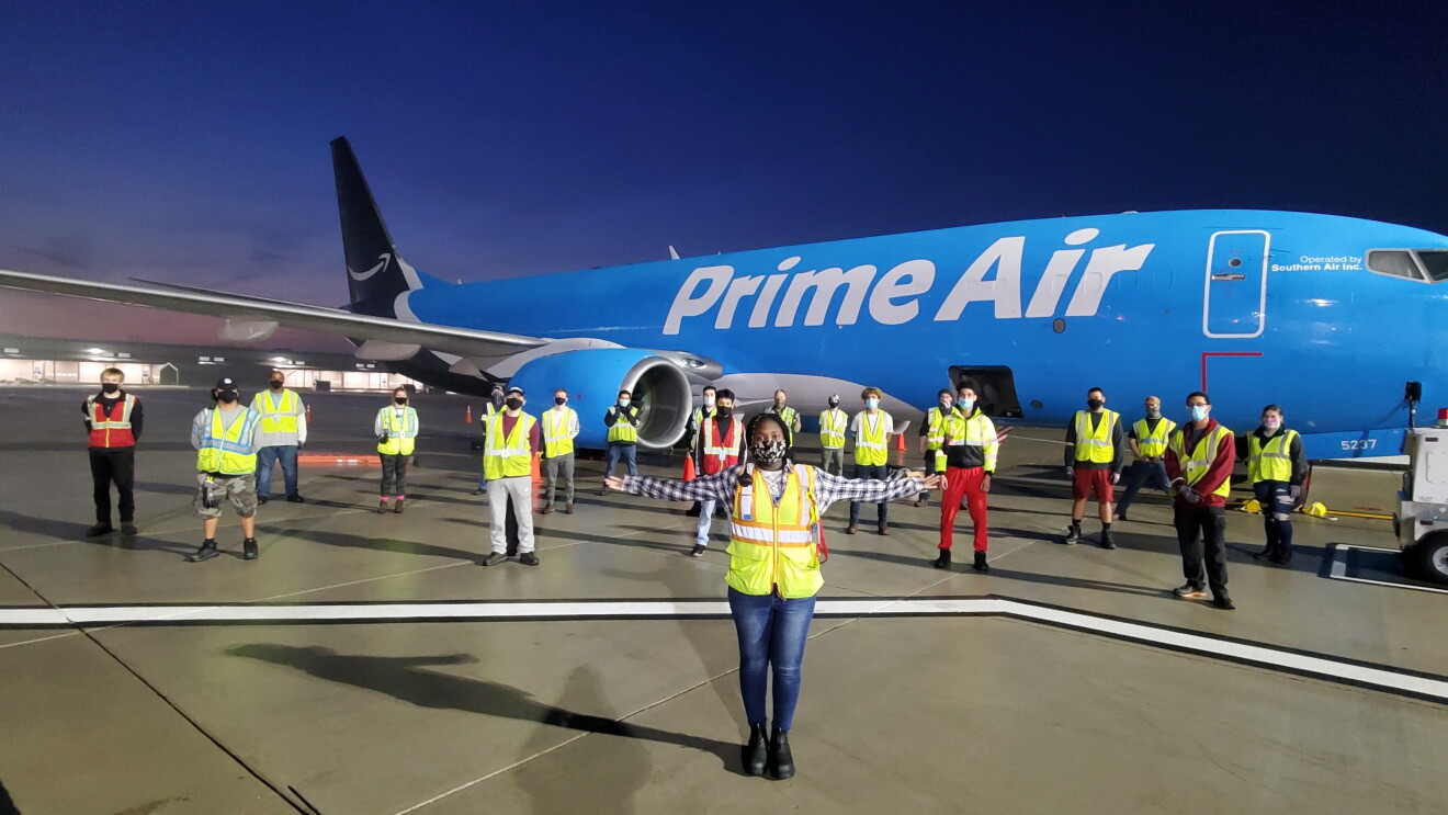 Amazon employees who work on the middle mile, posing for the camera at work