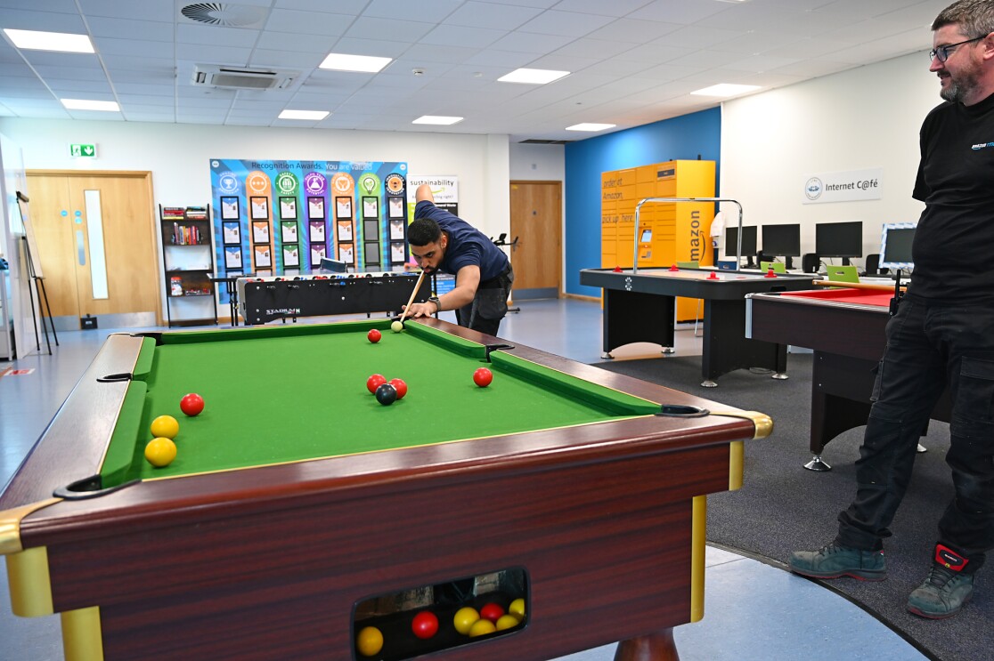 Staff play pool in the cafeteria.