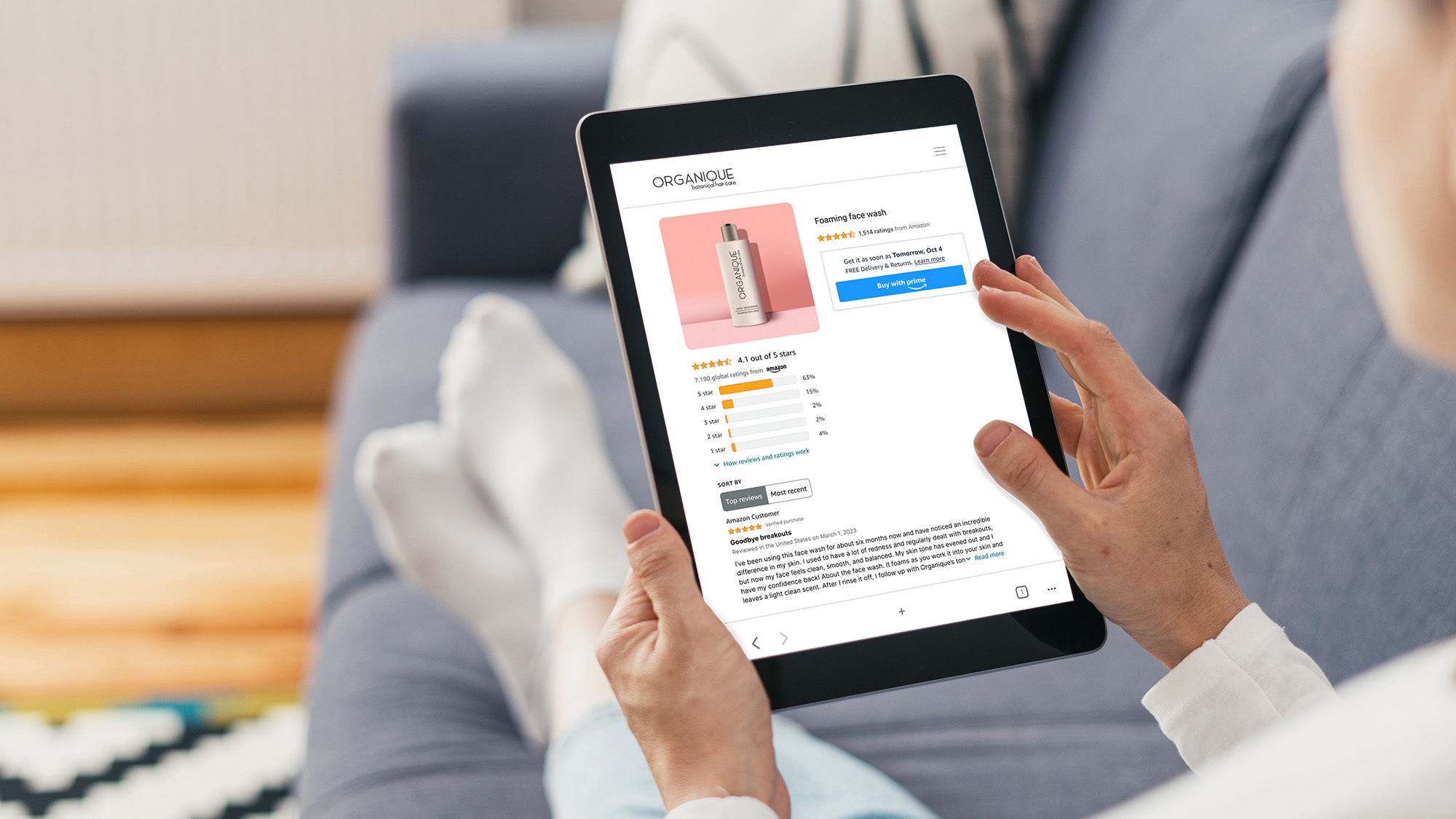 A photo of a customer holding a tablet, shopping for a beauty product. The Buy with Prime button is featured on the page.