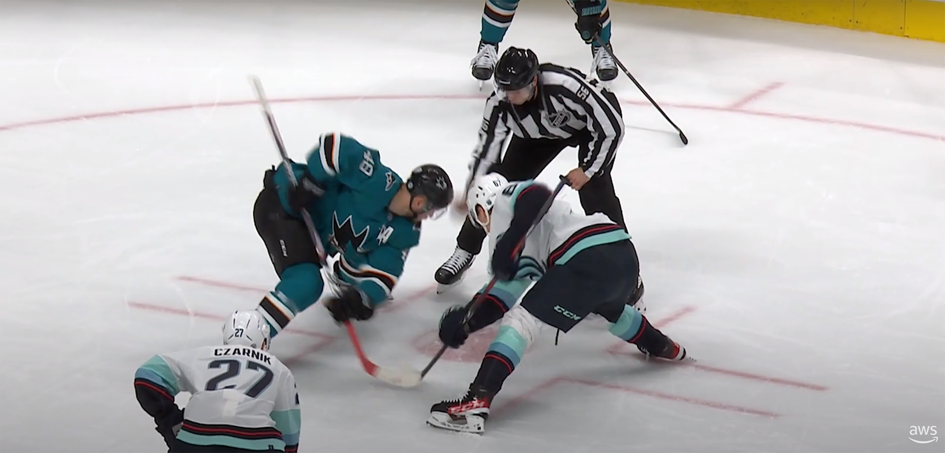 An image of hockey players facing off on the ice. 