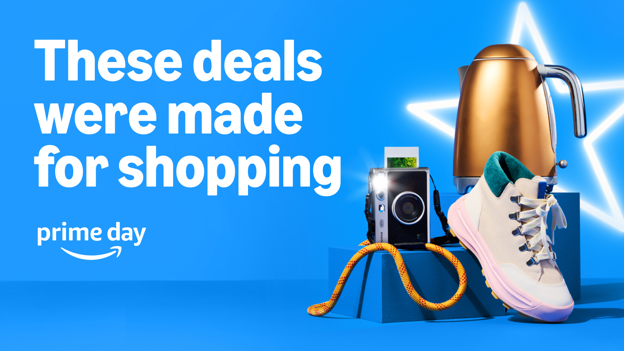 Text 'These deals were made for shopping', the prime day logo next to a camera, a golden electric kettle, and a shoe over a blue background.