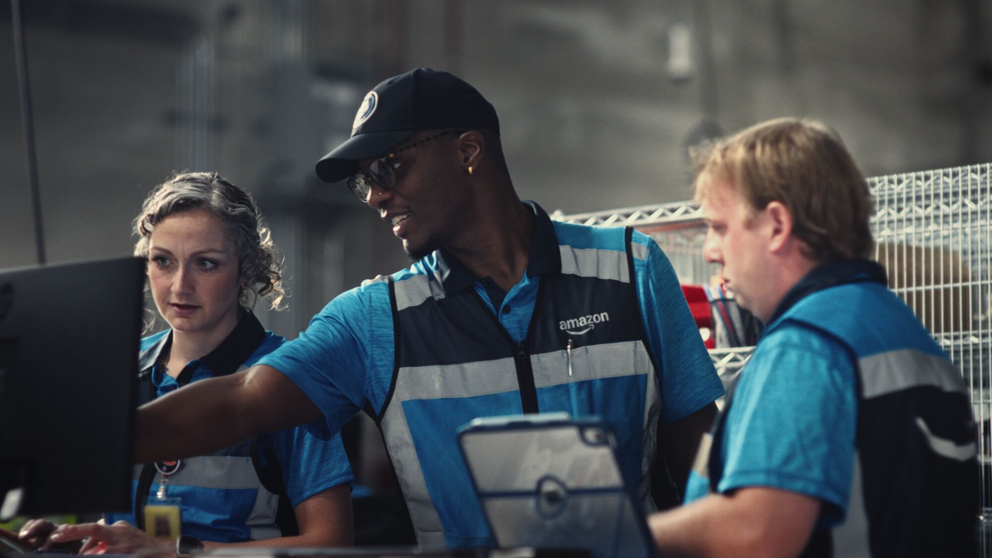 Amazon DSP owner Allan Ballard trains DAs and points at a computer screen.