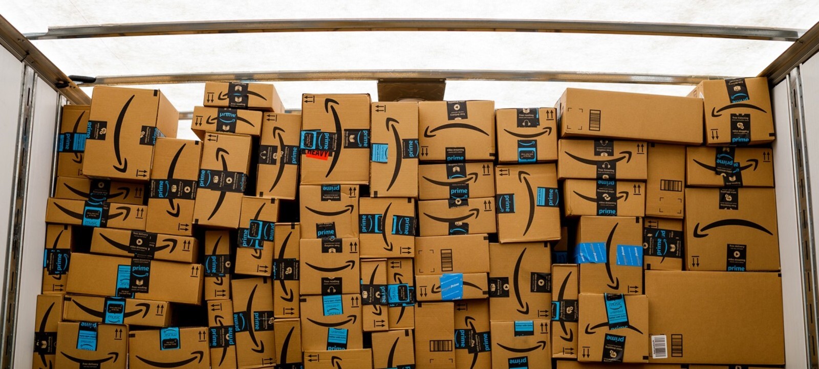 An Amazon delivery van with stacks of Amazon Prime delivery boxes ready for delivery.
