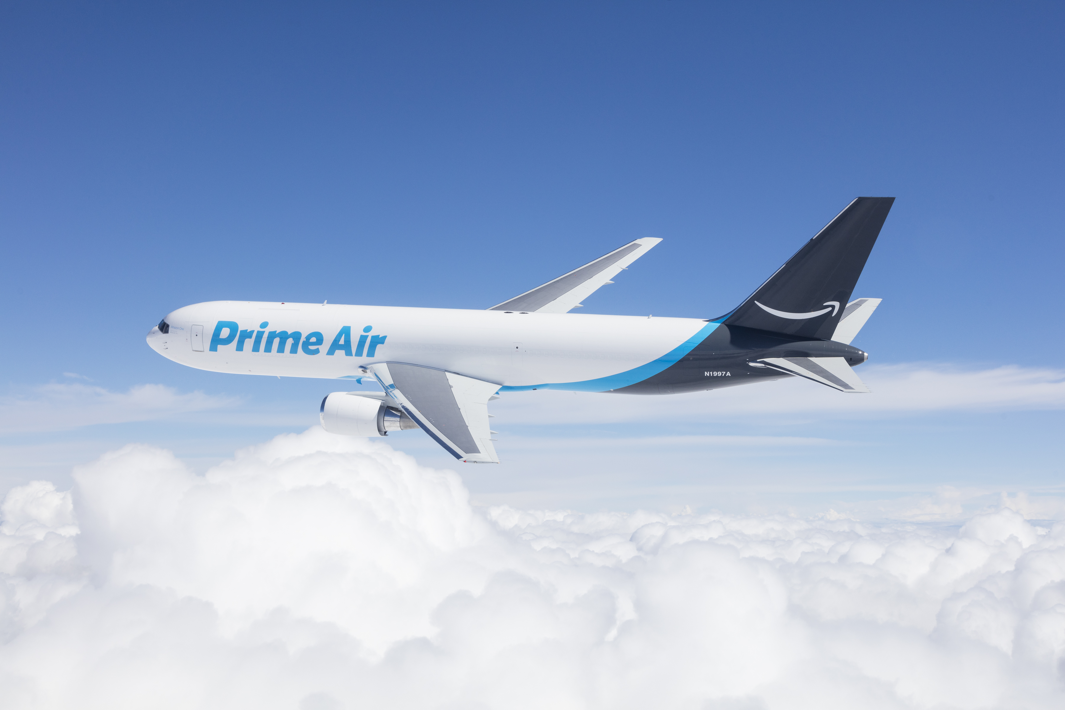 An Amazon Prime Air Boeing 767 flies above the clouds.