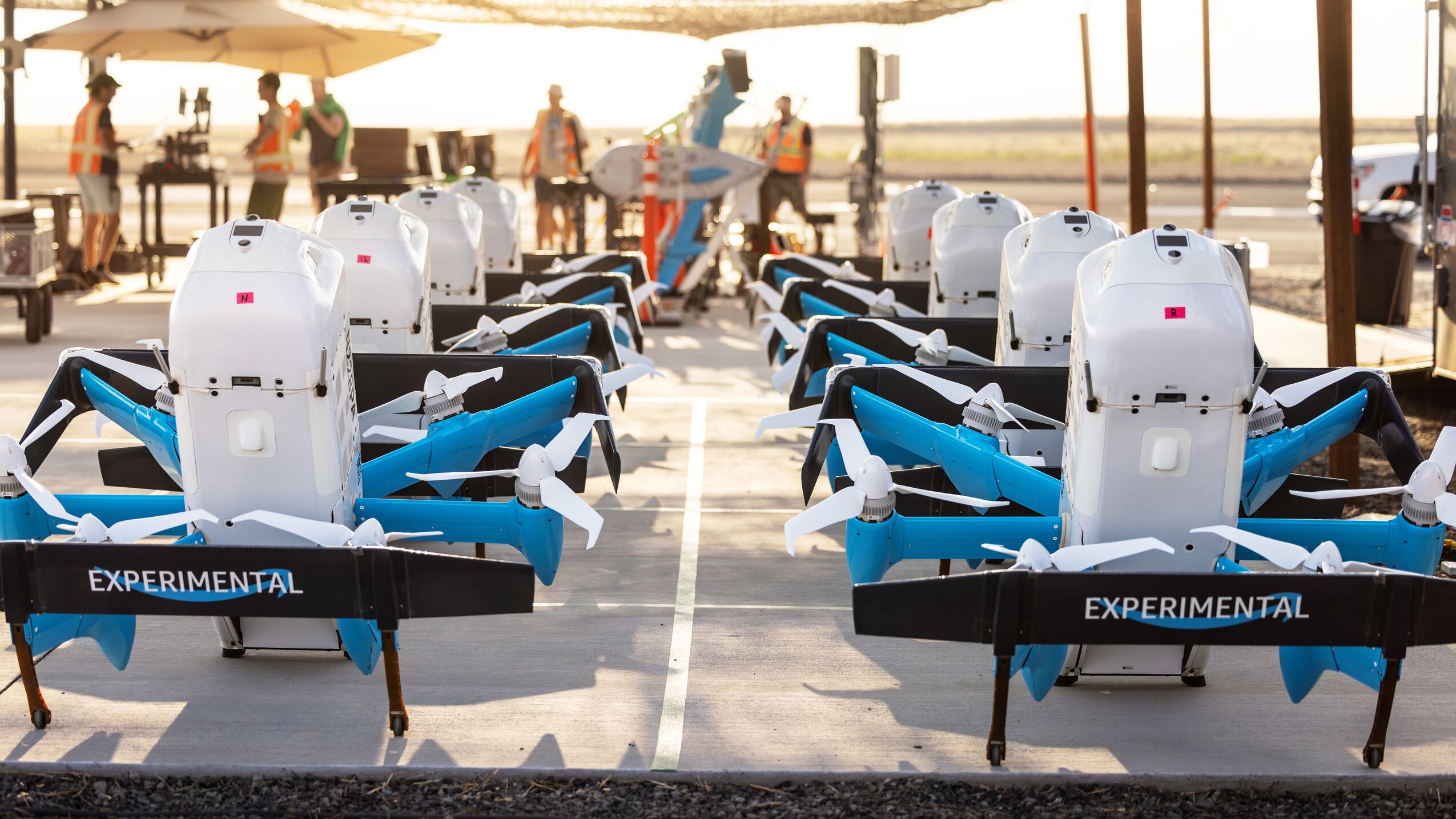 Experimental delivery drones lined up on tarmac