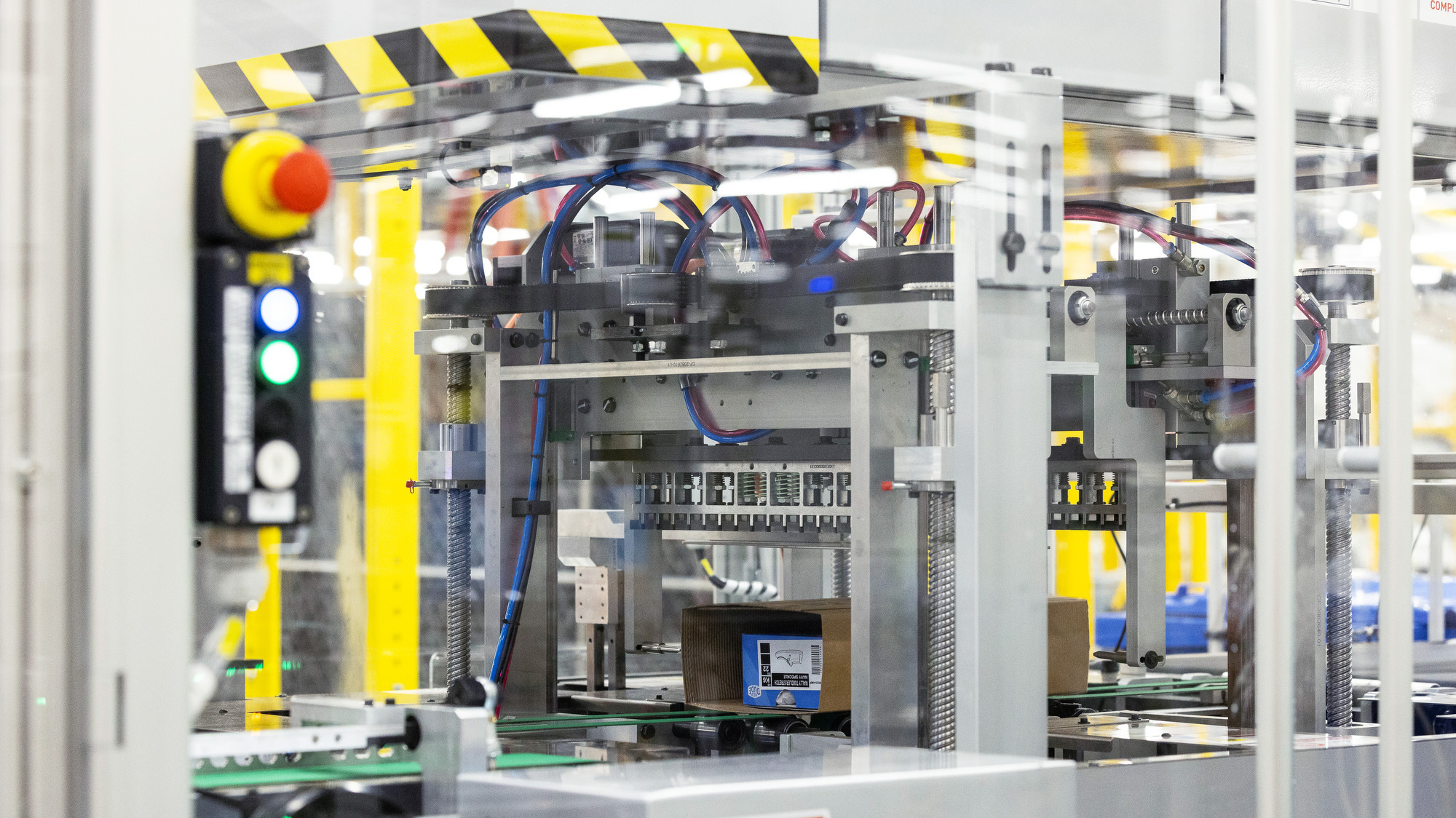 An image of a fulfillment center packaging station. 