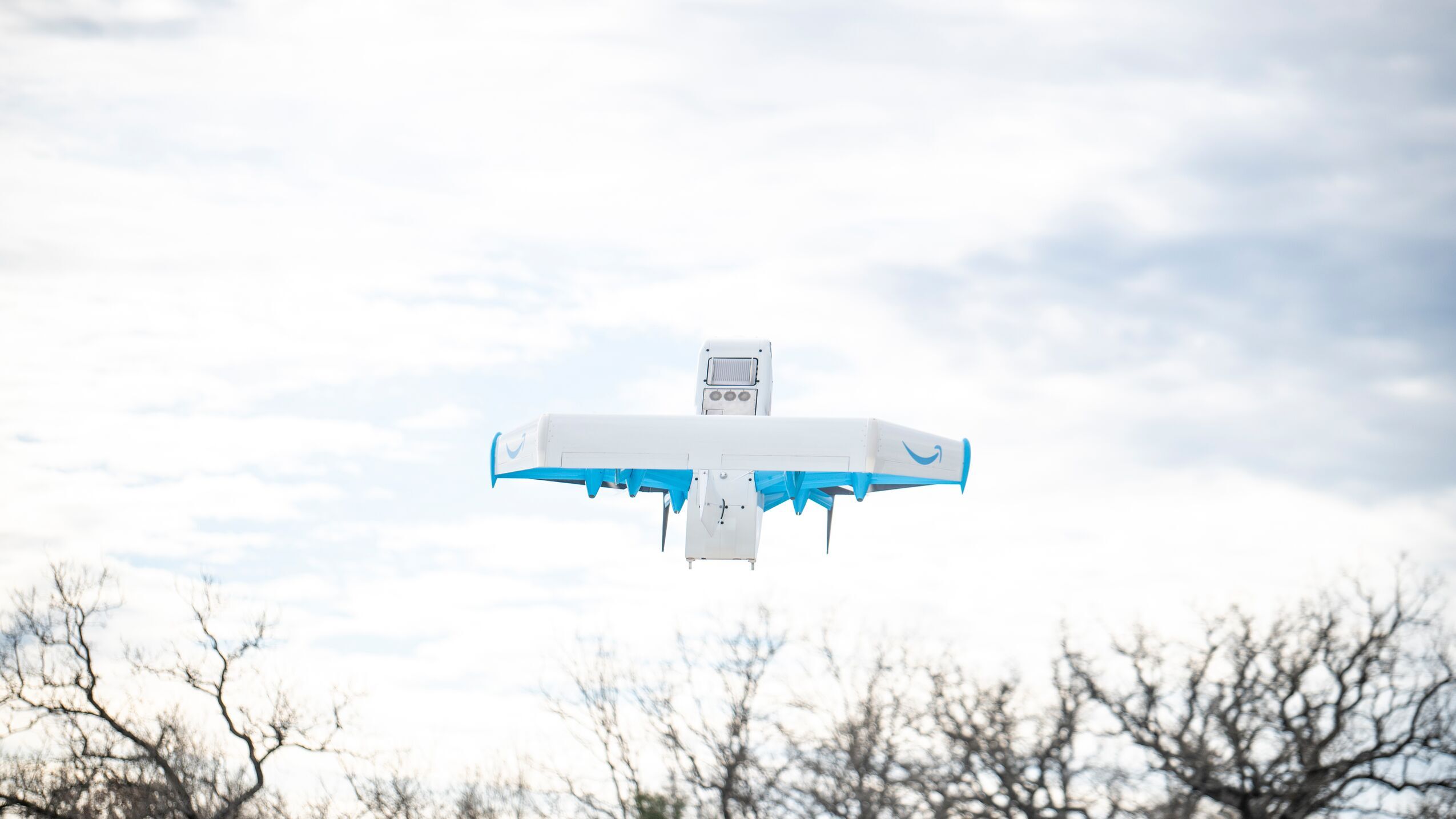 An image of an Amazon delivery drone flying in the air