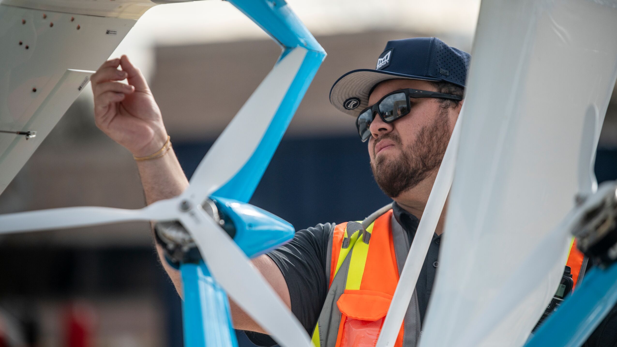 An image of an Amazon employee inspecting a propeller on a drone before it takes flight