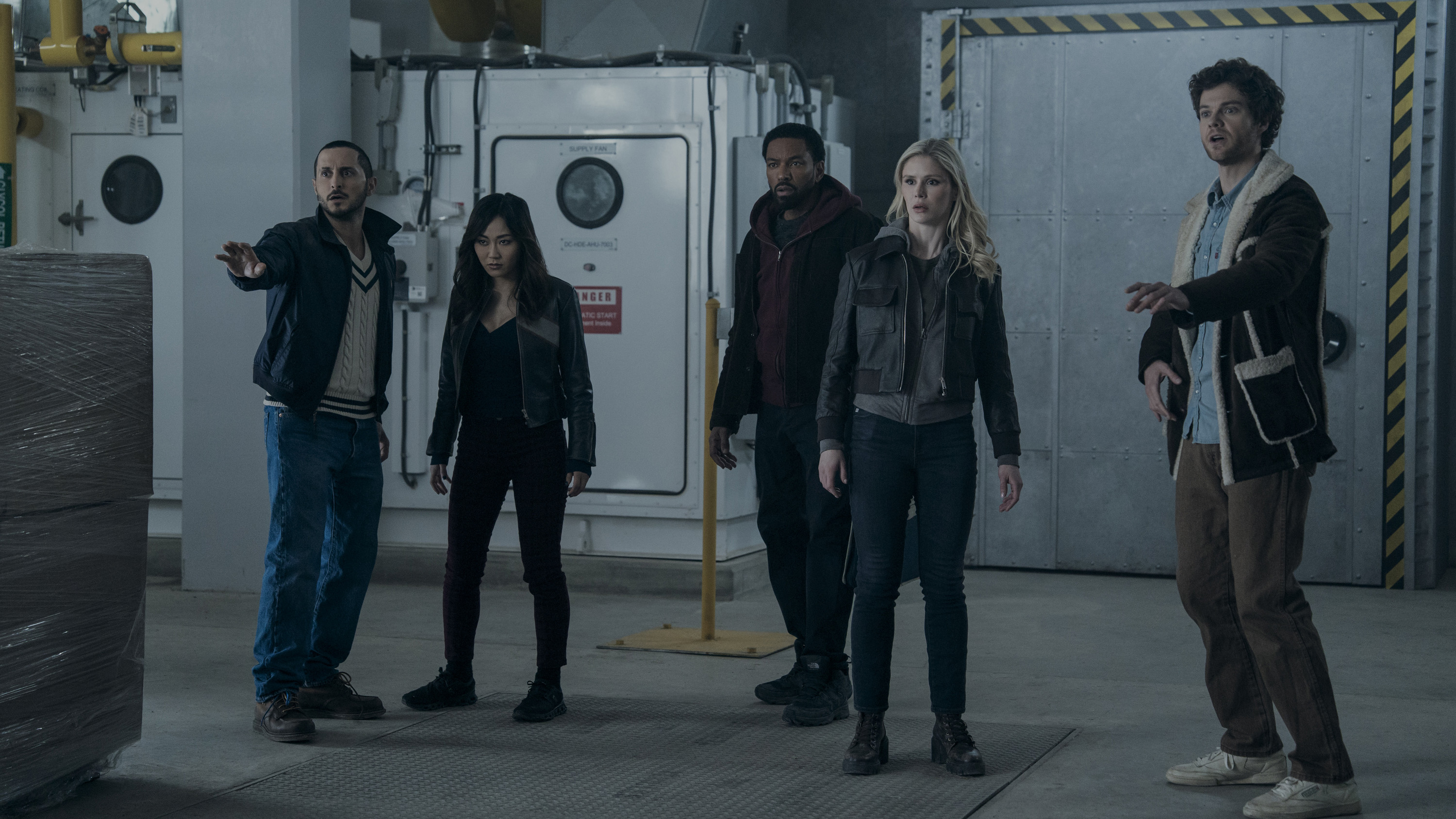 The Boys: Diverse group of five people standing in industrial setting
